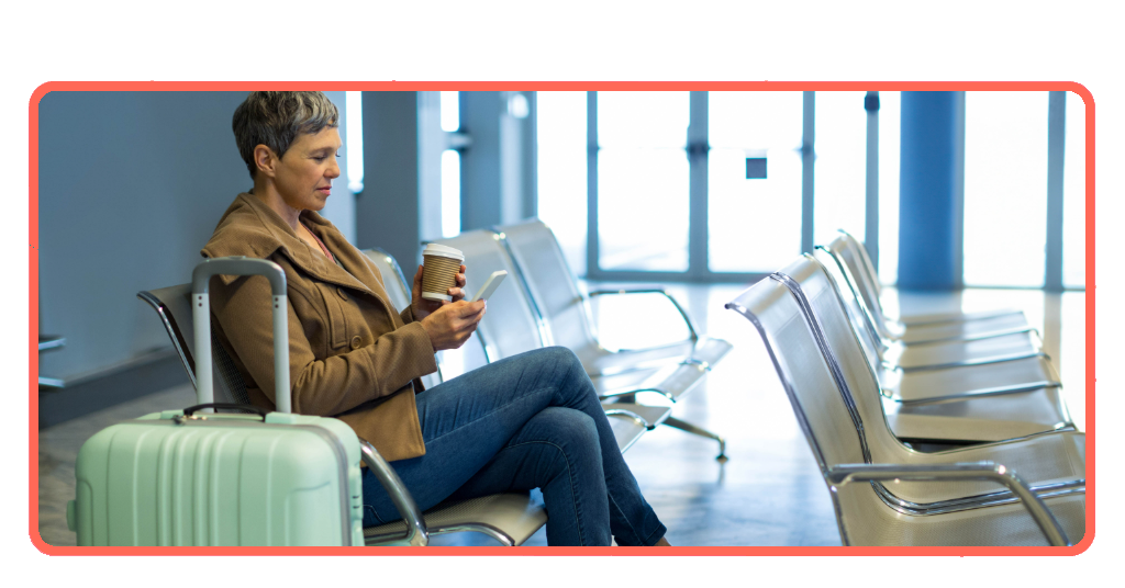 Woman using smartphone at airport waiting lounge